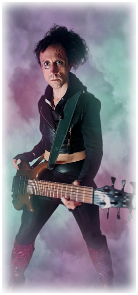 Front page hero shot of Ramelan, leather vest, pants and red stiletto boots, electric bass in hand and Vahkri makeup symbols visible